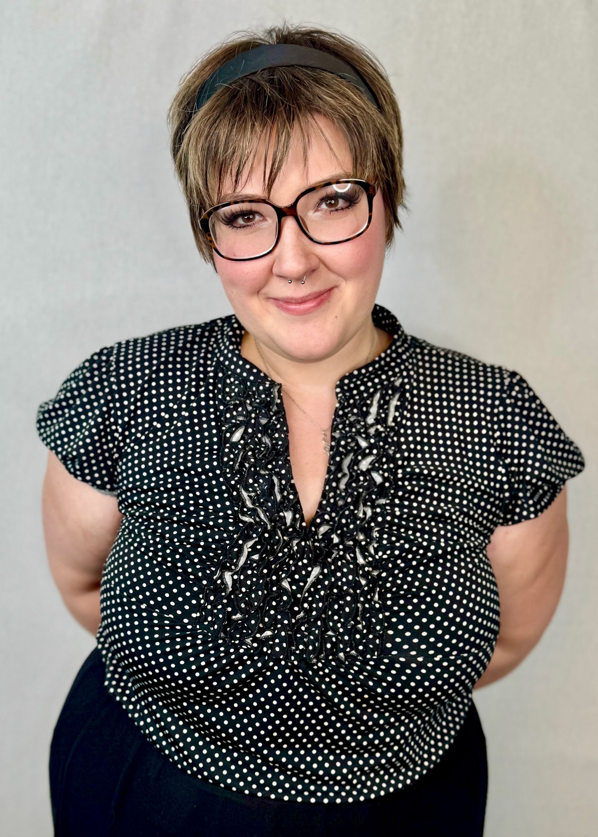 A person is applying pink nail polish to their nails