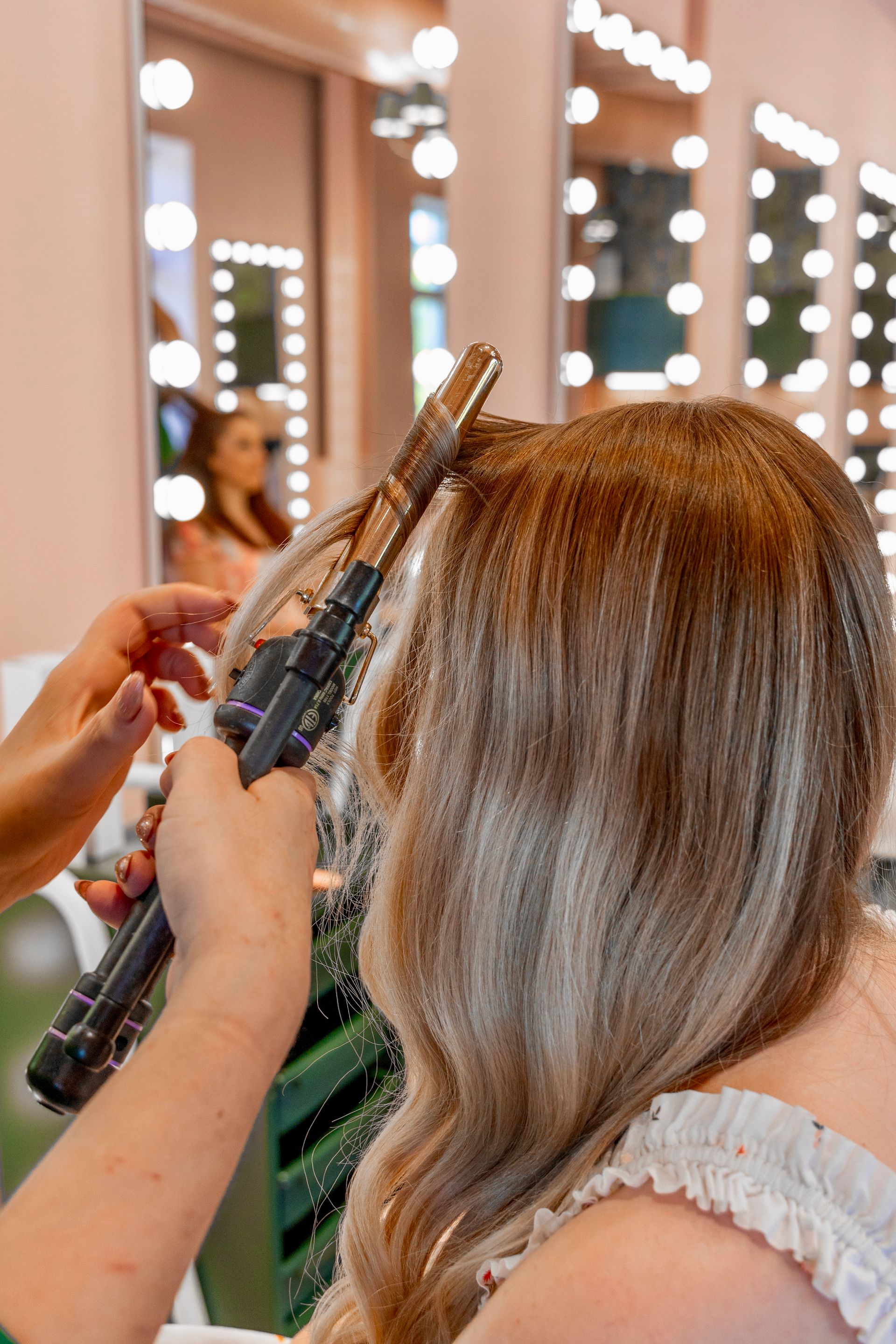 woman in a green dress touching her hair