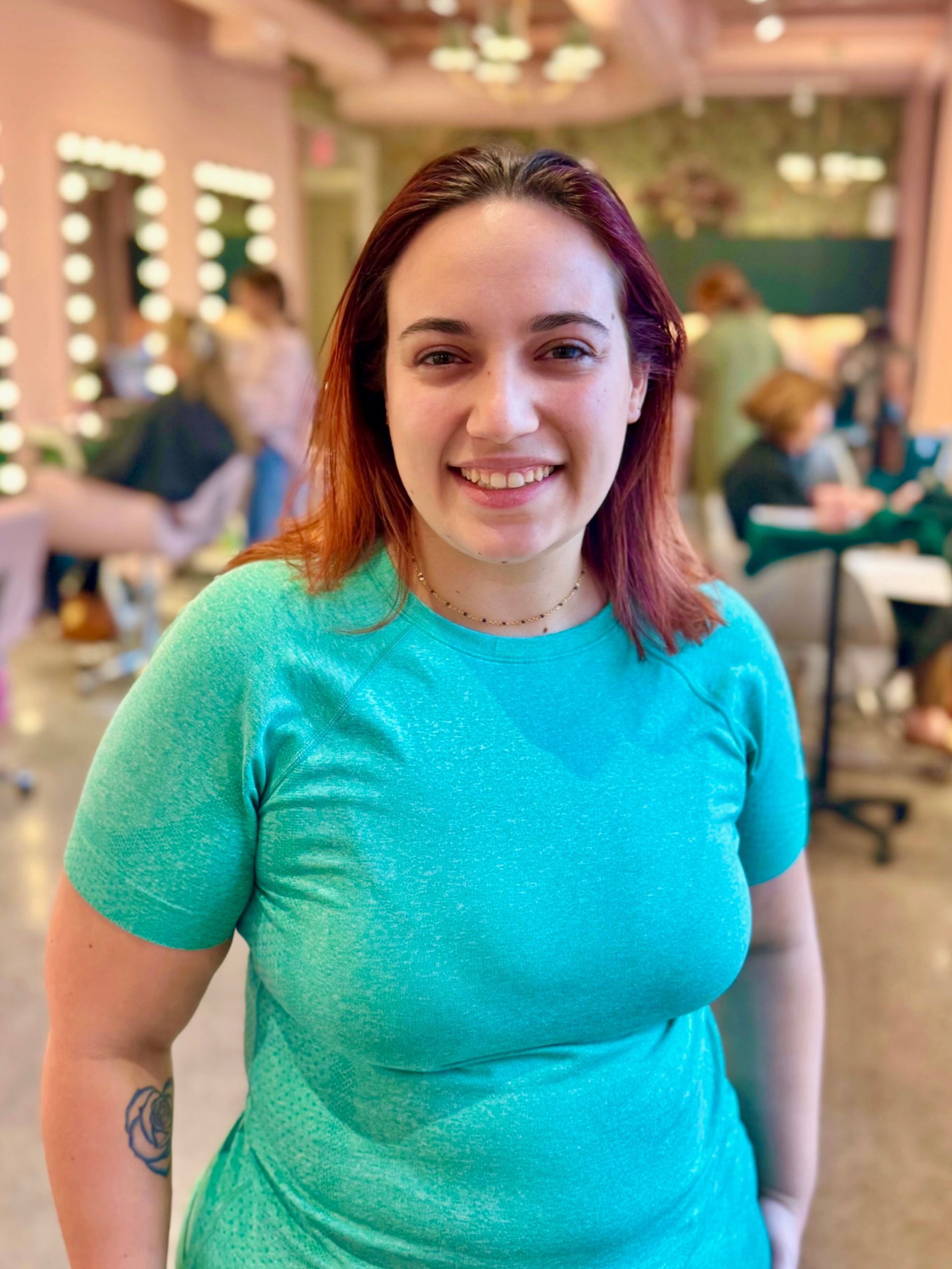 A woman wearing a black babor shirt is smiling for the camera.
