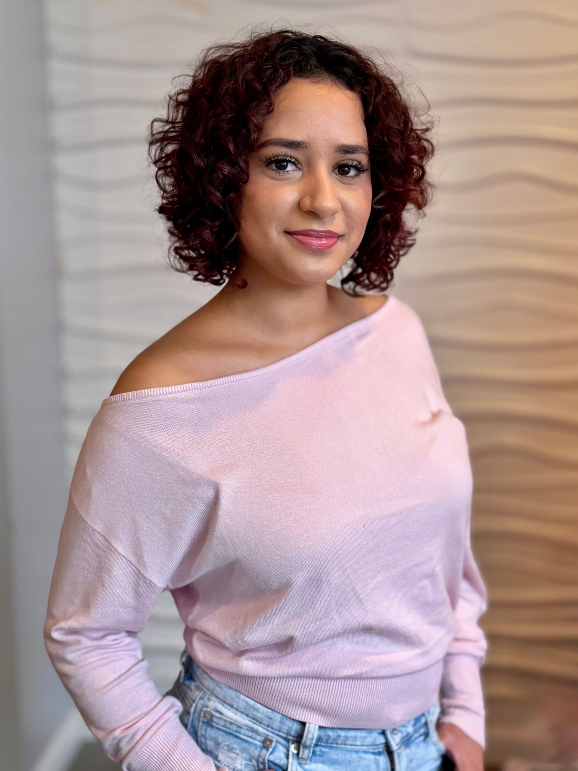 A woman in a black shirt is sitting in a chair