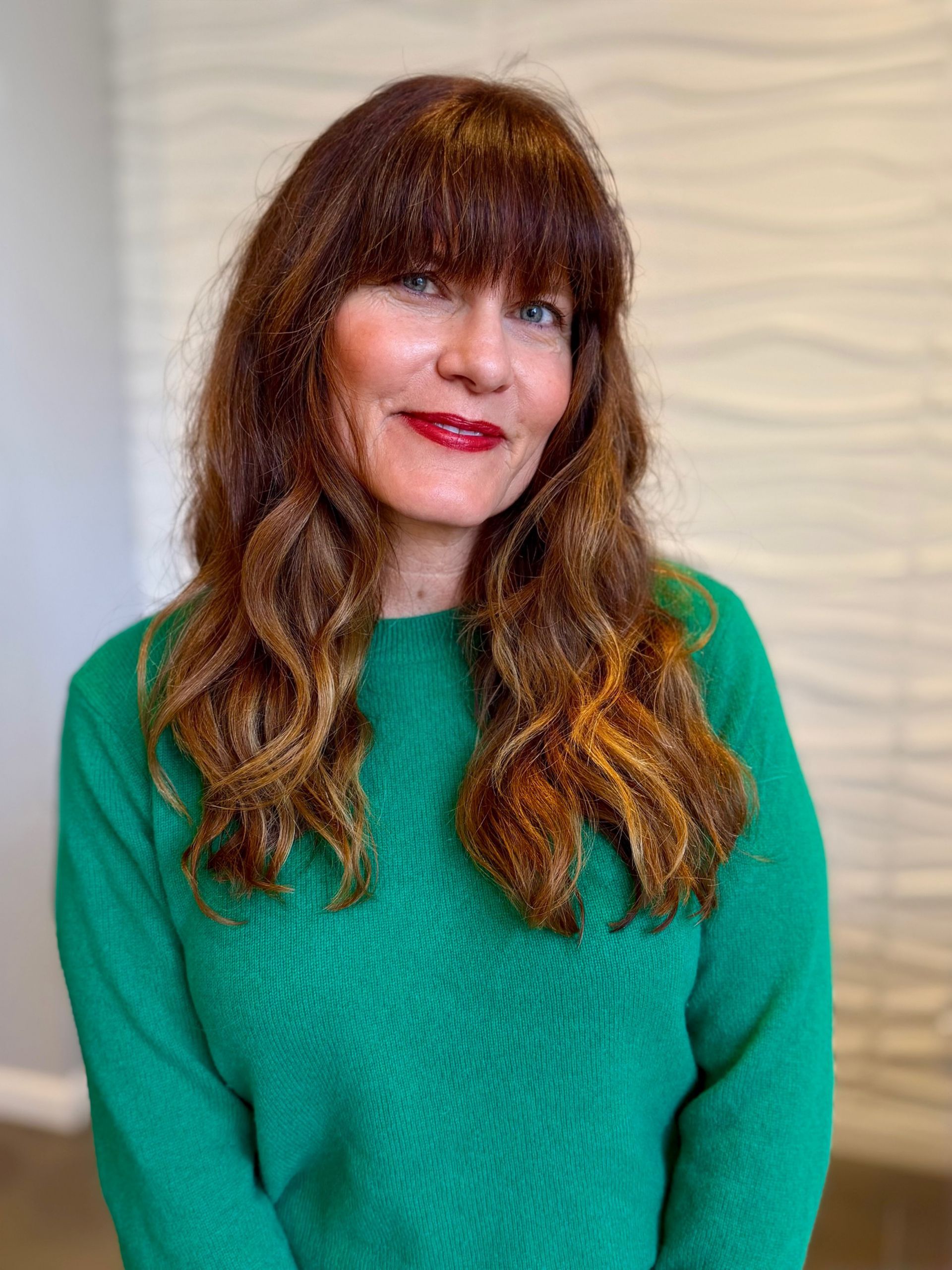 Hairdresser cutting hair with scissors and comb.