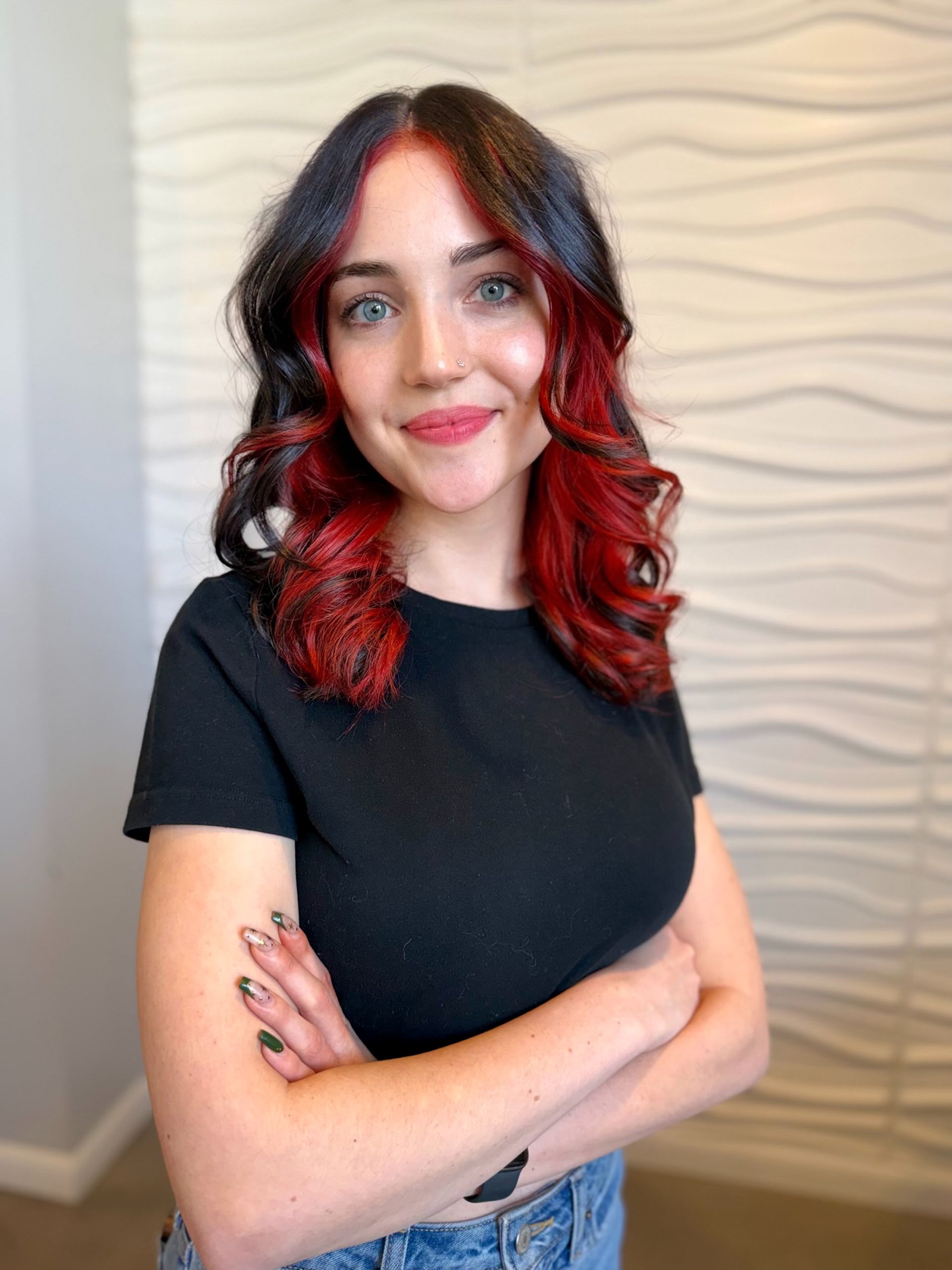 A woman is getting her hair blow dried with a round brush.
