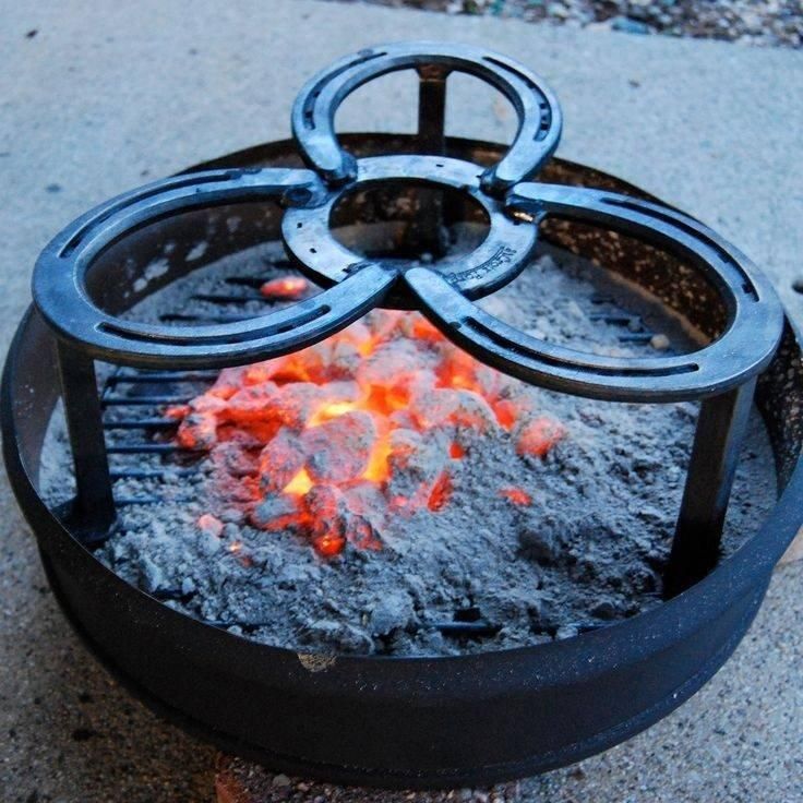 A fire pit with horseshoes on top of it