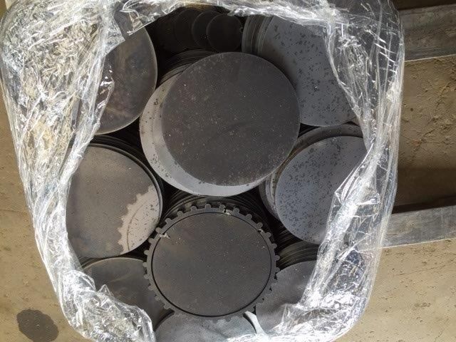 A bag of metal circles is wrapped in plastic.