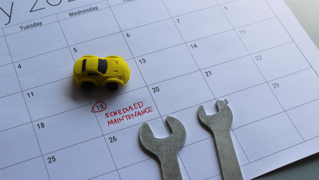 A calendar with a toy car and a wrench on it | Karta Motorwerks