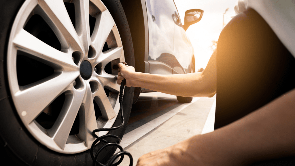 A person is pumping air into a car tire | Karta Motorwerks