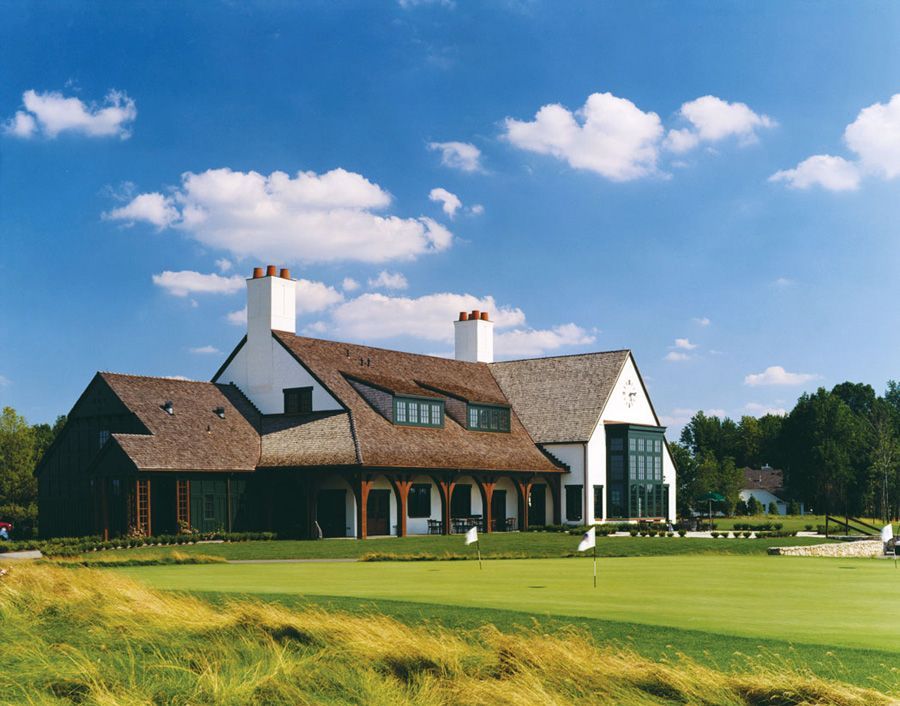 A large house sits in the middle of a golf course