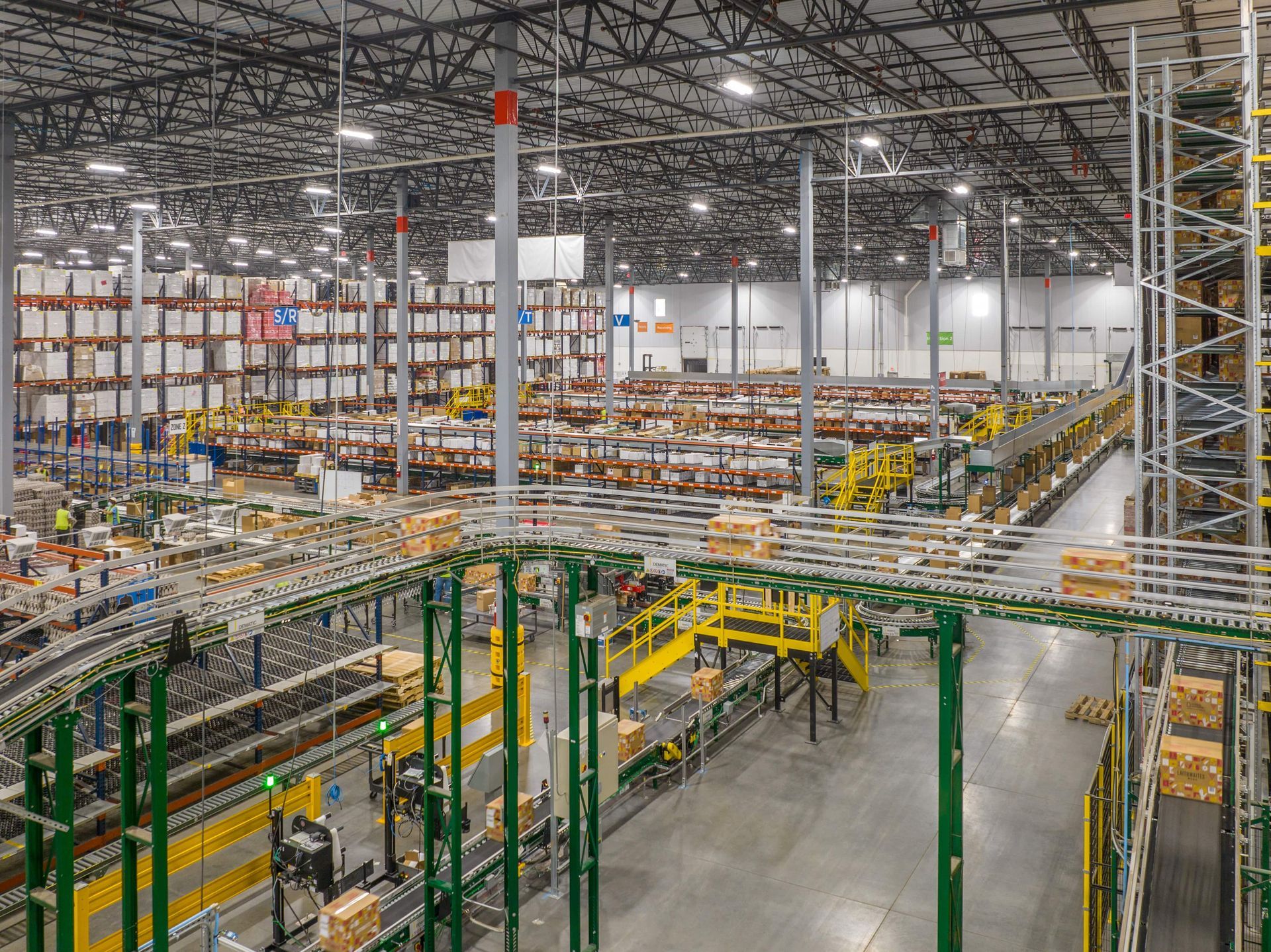 An aerial view of a large warehouse filled with shelves and conveyor belts.