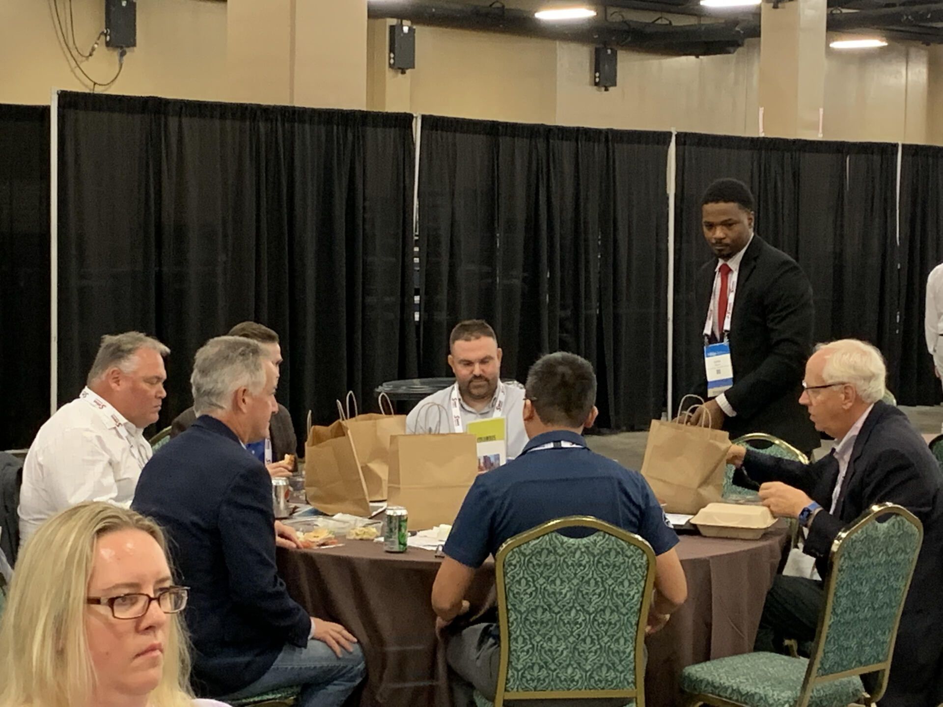 A group of people are sitting at tables in a room.