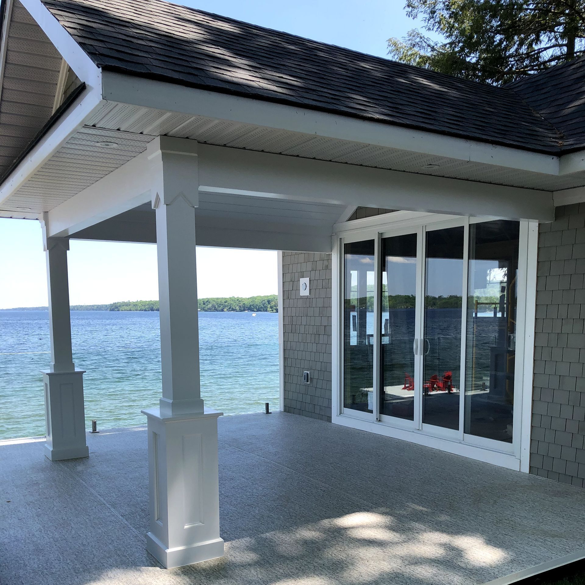 A house with a patio overlooking a body of water