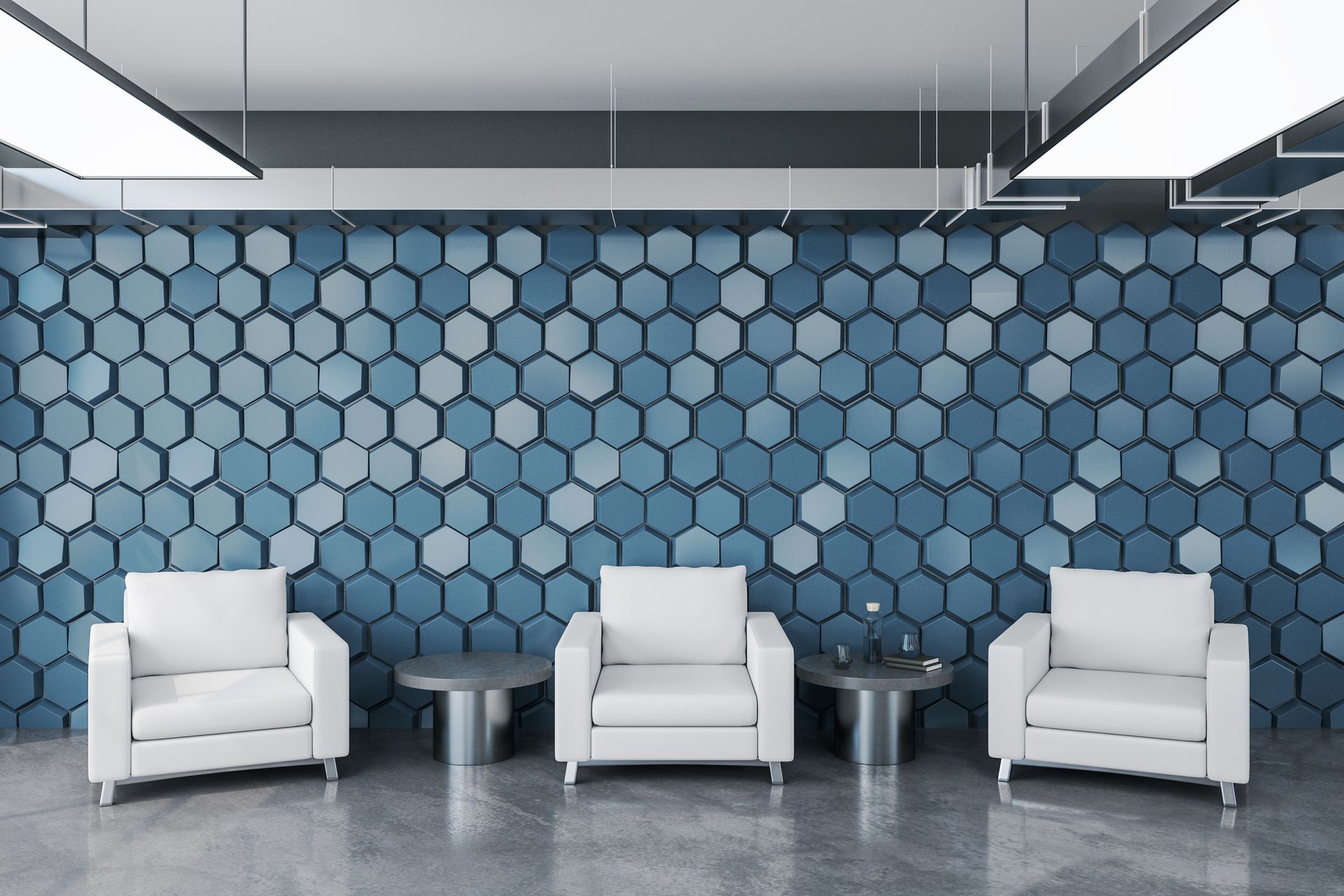 Three white chairs are sitting in front of a blue wall with hexagons on it.