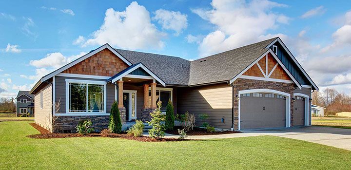 Large modern house with stone and walkway. 
