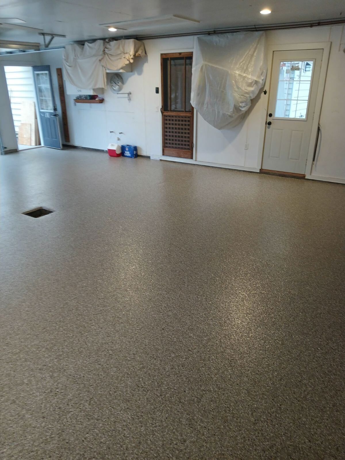 A garage with a concrete floor and a door.