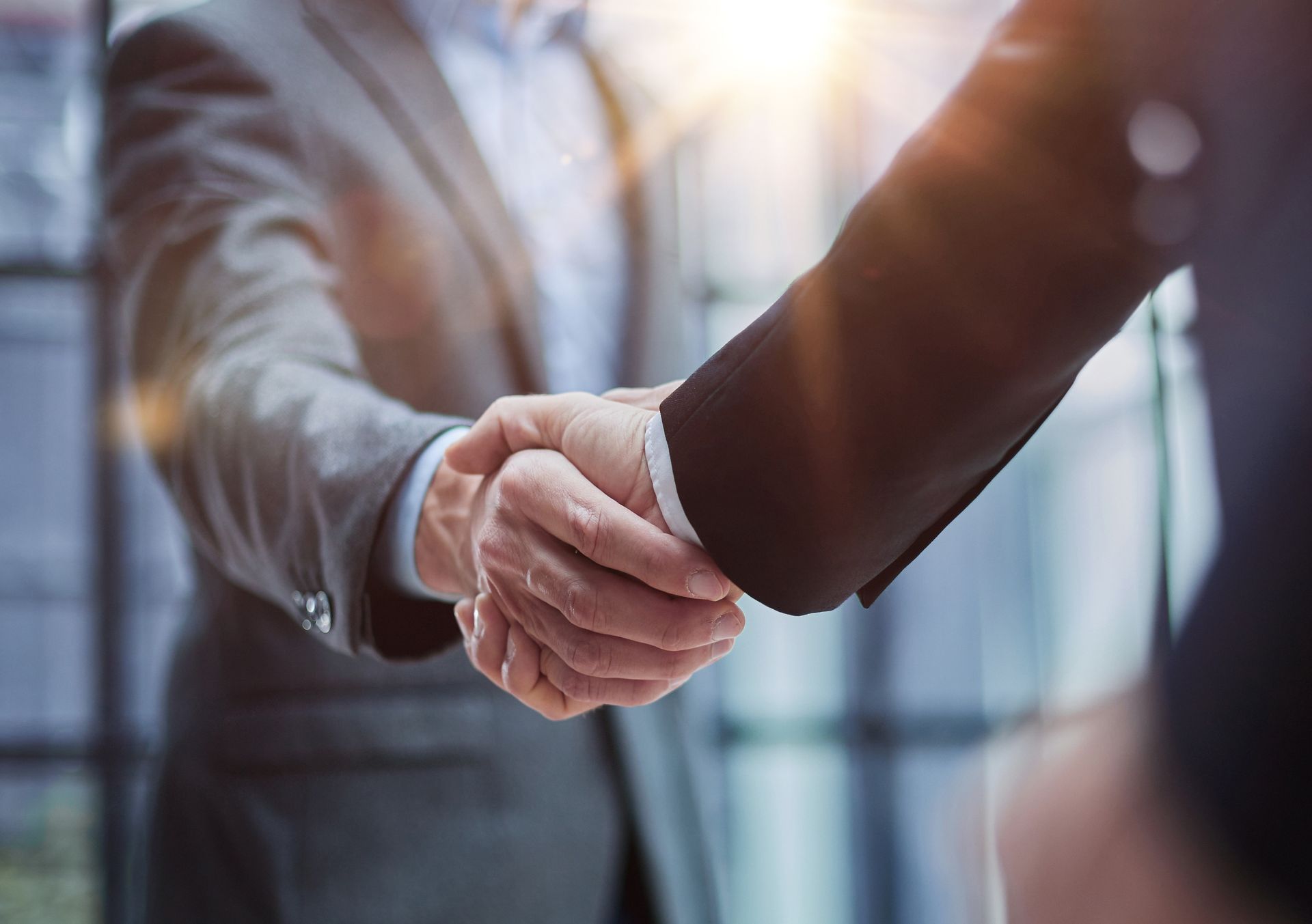 Two people shaking hands, likely in a business setting, as a sign of agreement or partnership.