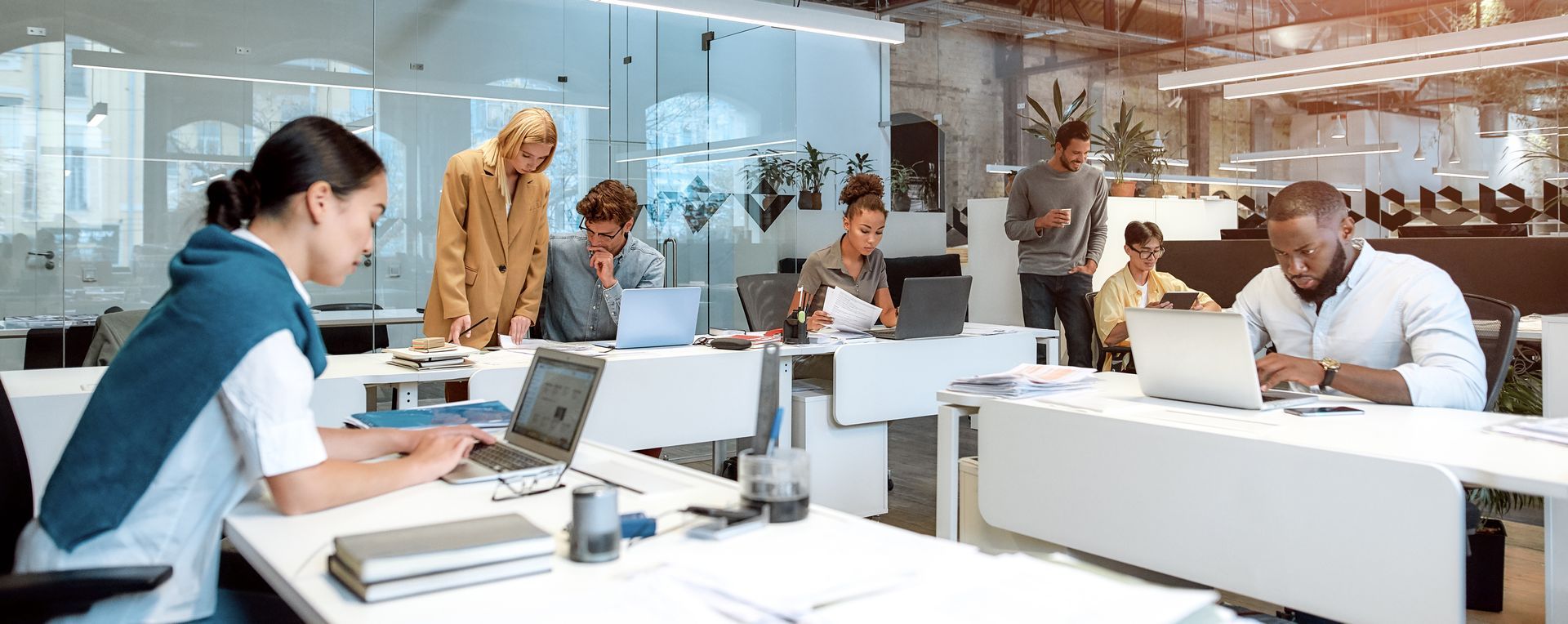 People working on laptops in an office setting.
