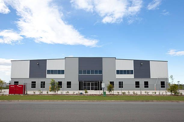 A Large Building With A Blue Sky And White Clouds In The Background – Bannockburn, VIC - Kevin Connors Painters & Decorators