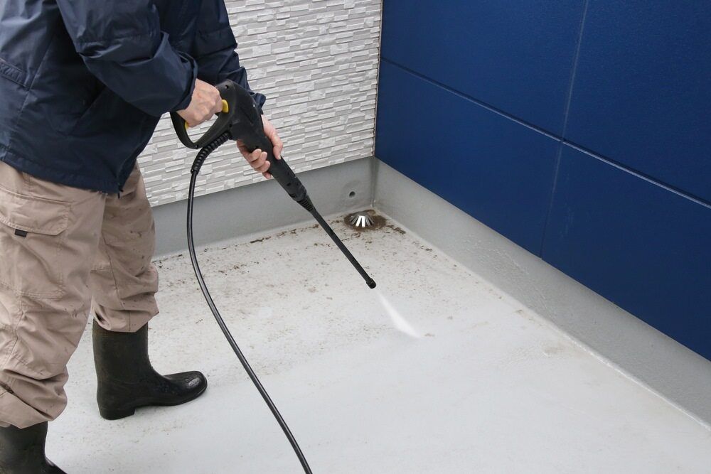 Man Cleans The Floor Using Water Pressure — Toowoomba Cleaning Co in South Toowoomba, QLD
