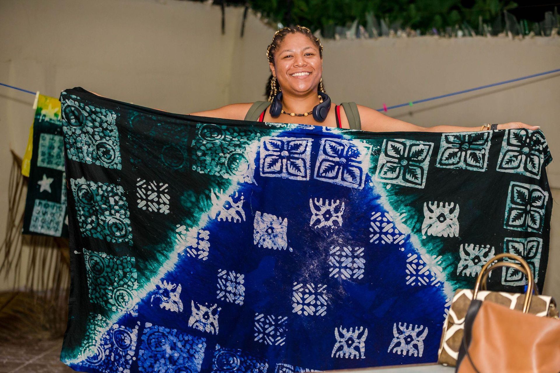 A woman is holding a blanket with a map of the world on it.