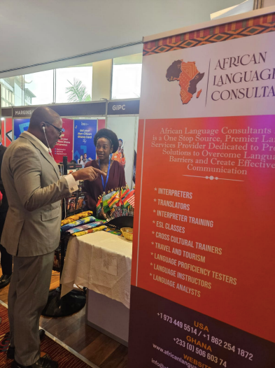 A man standing in front of a sign that says african language consulta