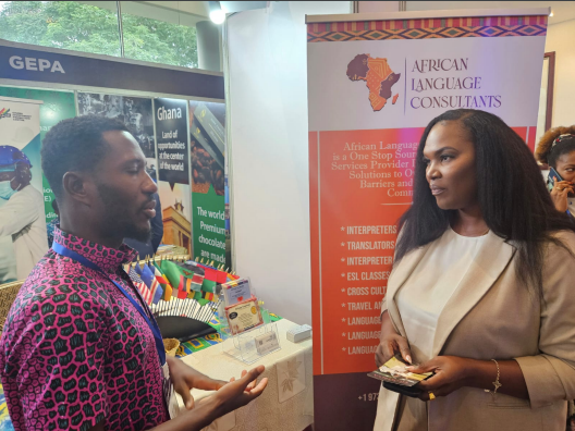 A man and a woman are standing in front of a sign that says african language consultation