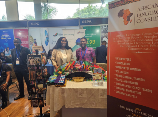 A group of people standing around a table with a sign that says african language council