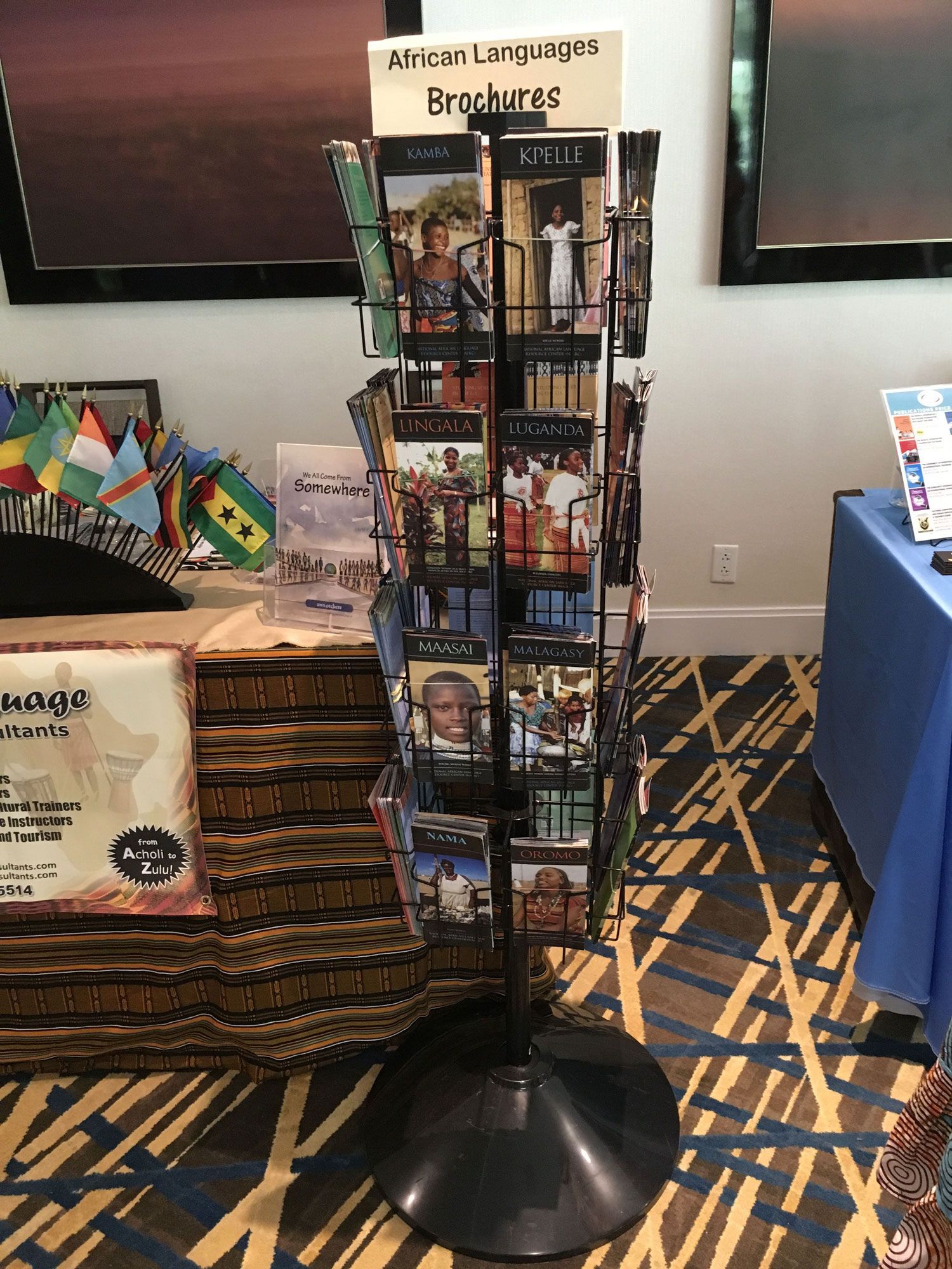 A brochure stand with brochures on it is in a room.