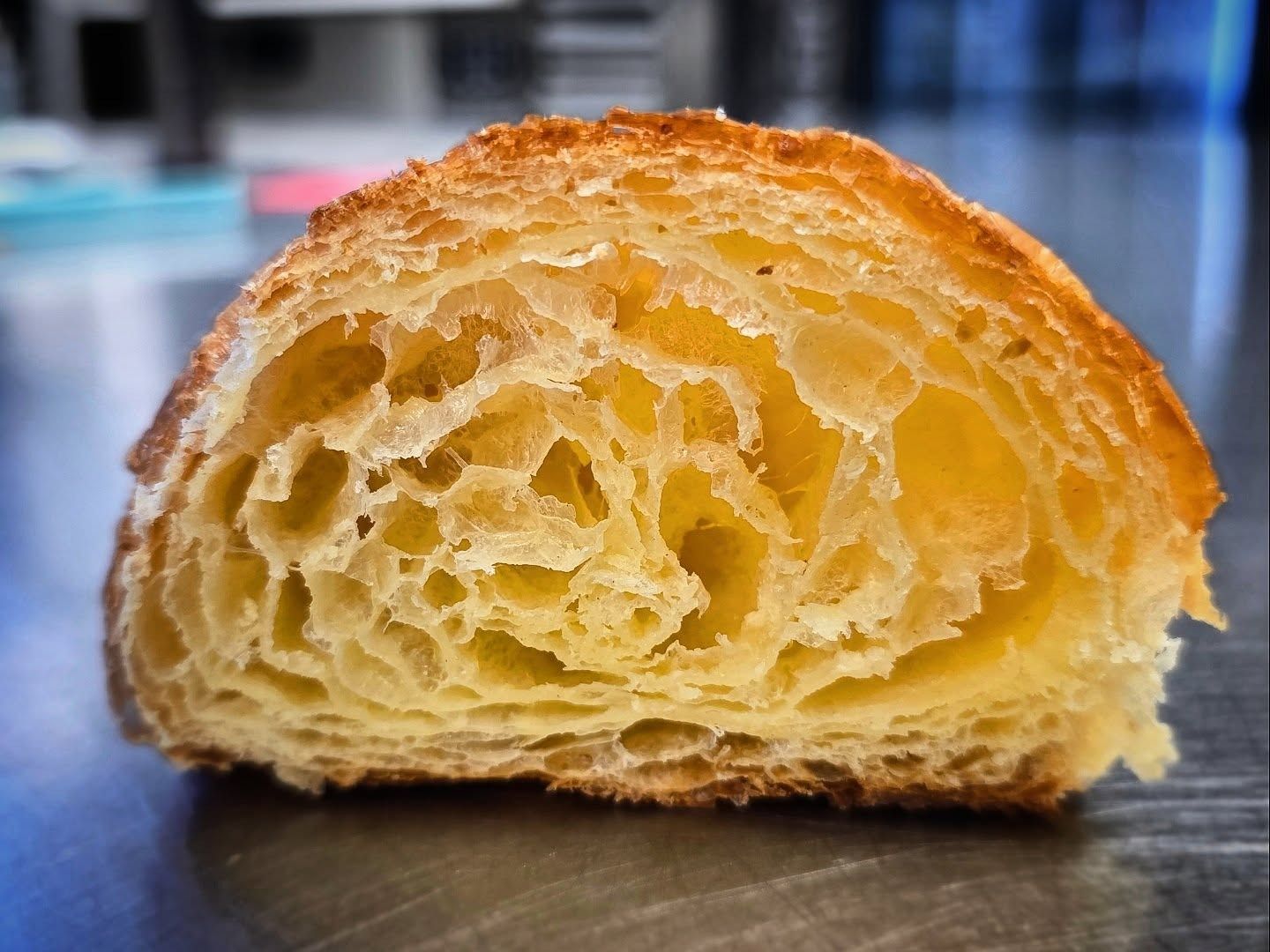 Sezione trasversale di un croissant, che mostra numerosi strati ariosi e una crosta dorata.