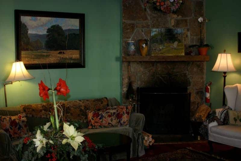 A living room with a fireplace and a painting on the wall