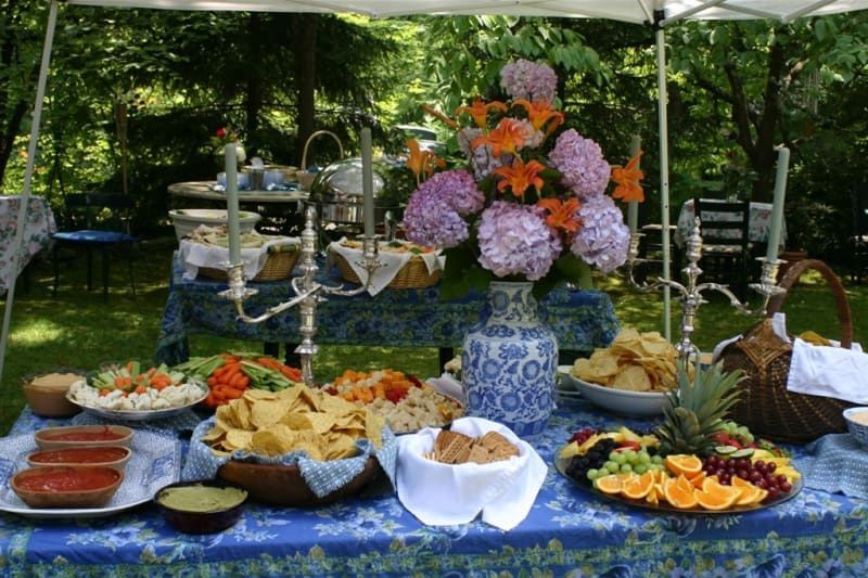 A table with a variety of food and flowers on it
