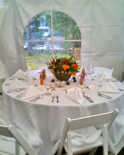 A white table with a vase of flowers on it