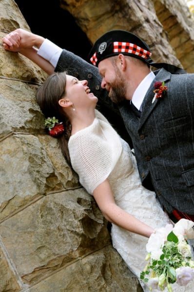 A bride and groom are posing for a picture on their wedding day