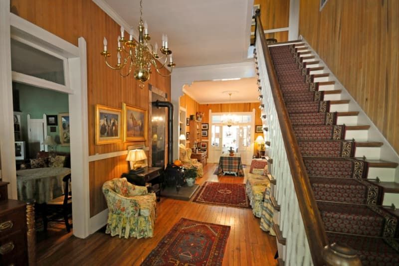 A hallway with stairs leading up to a living room