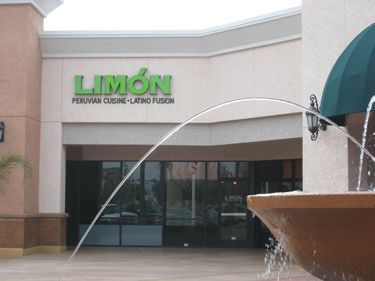 A fountain in front of a restaurant called limon