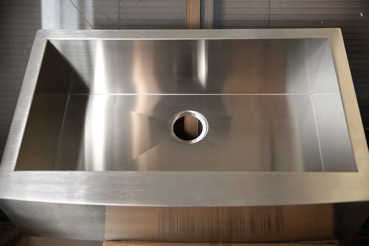 A stainless steel sink with a hole in the middle