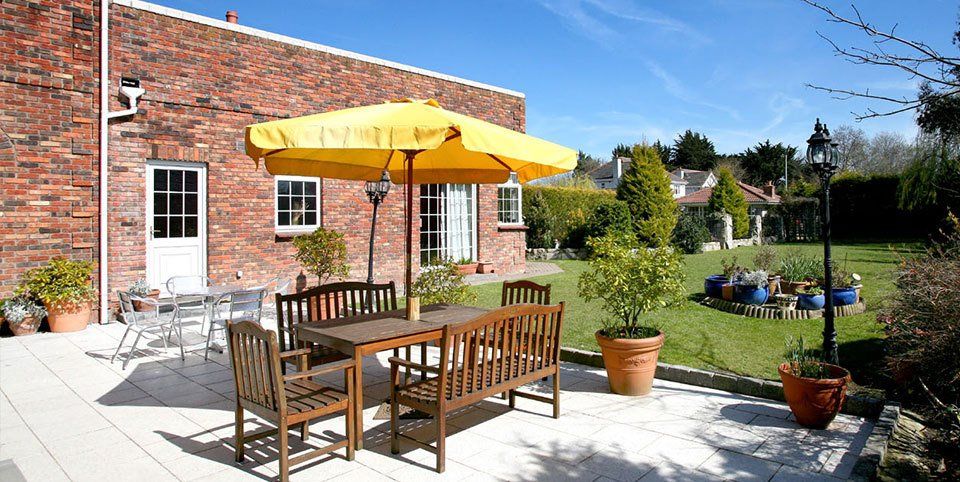 A large garden with a patio area