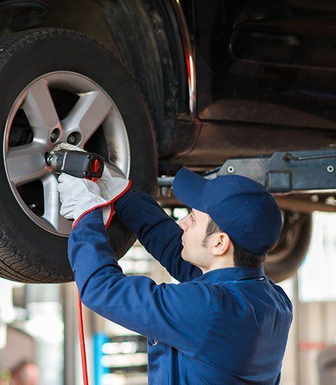 Mechanic Replacing the Wheel - Hillsborough, NC - Talbert’s Automotive & Tire