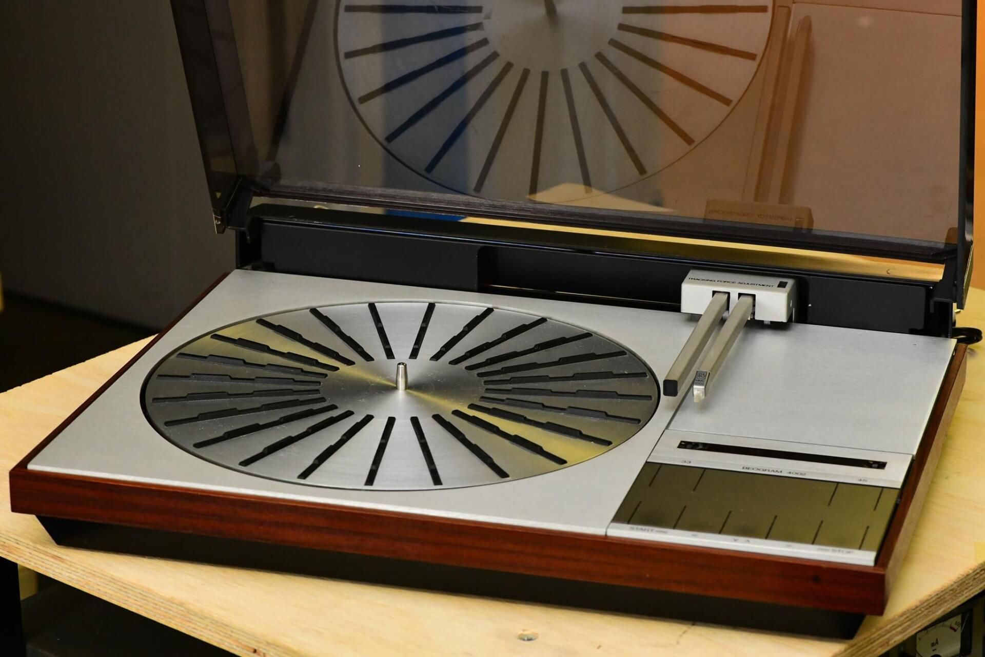 A record player is sitting on a wooden table