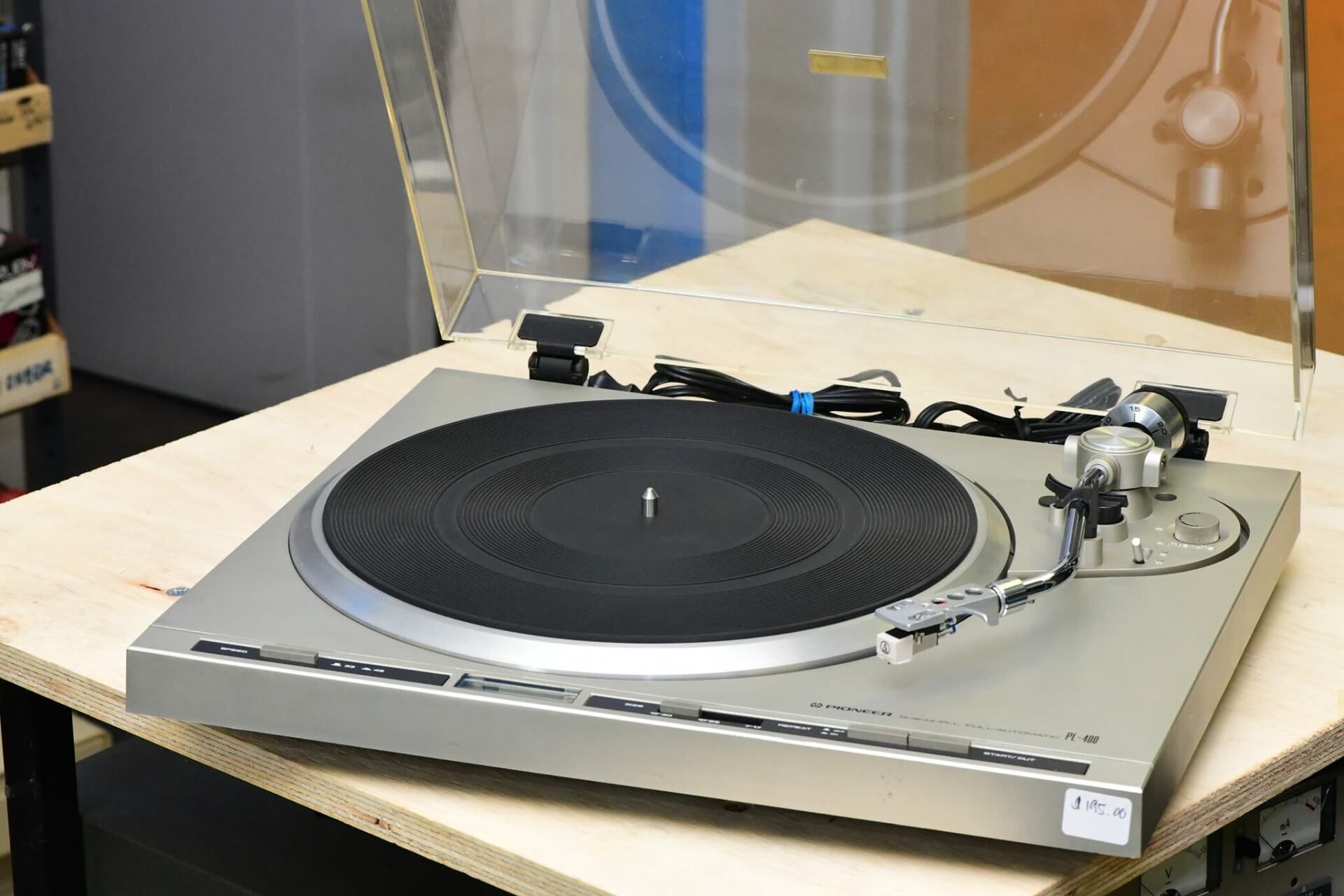 A record player is sitting on a wooden table.