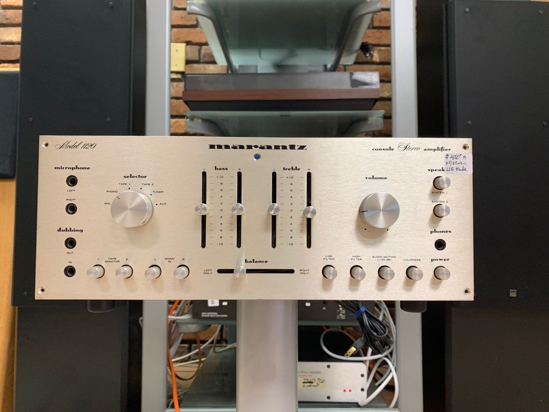 A marantz amplifier is sitting on a stand