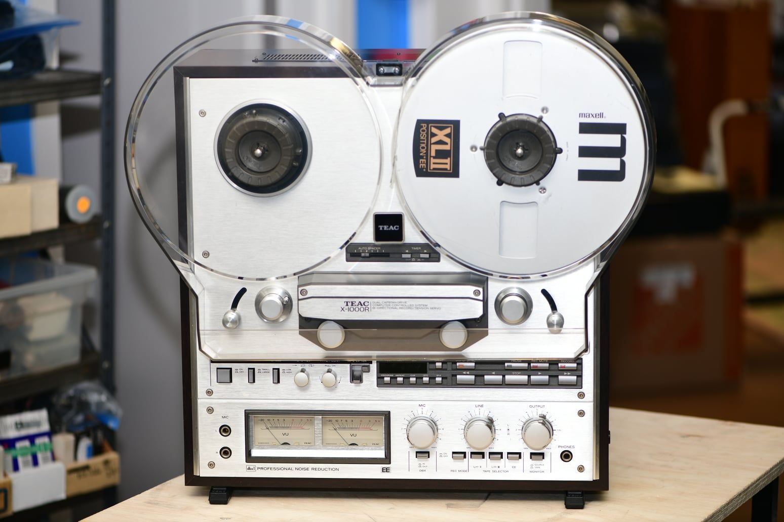 A tape recorder is sitting on a wooden table.
