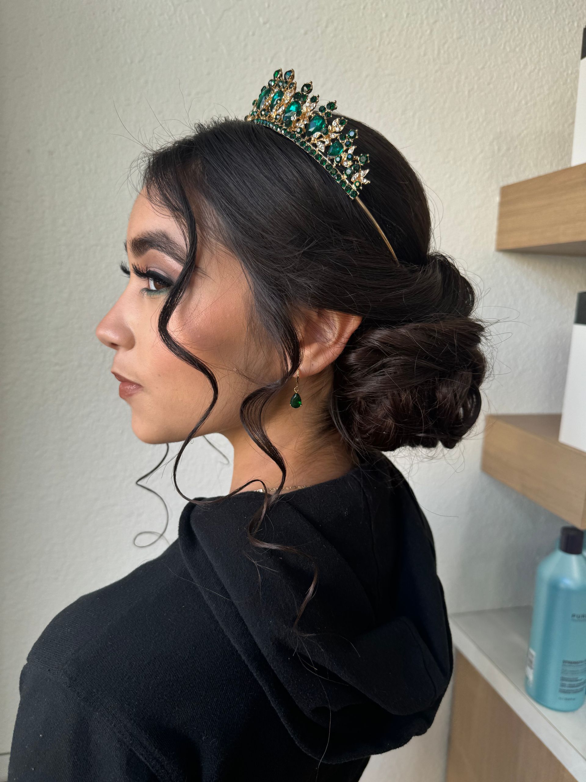 A woman wearing a black hoodie and a green tiara