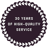 A 30 years of high quality service badge with a laurel wreath around it.