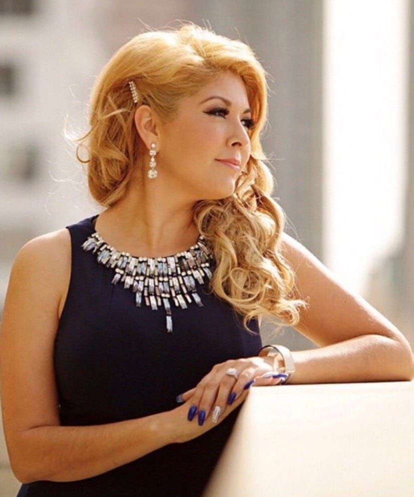 A woman is getting her makeup done by a makeup artist.