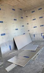 A room with a lot of sheets of styrofoam on the floor.