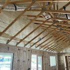 A large room with a wooden ceiling and a lot of windows.