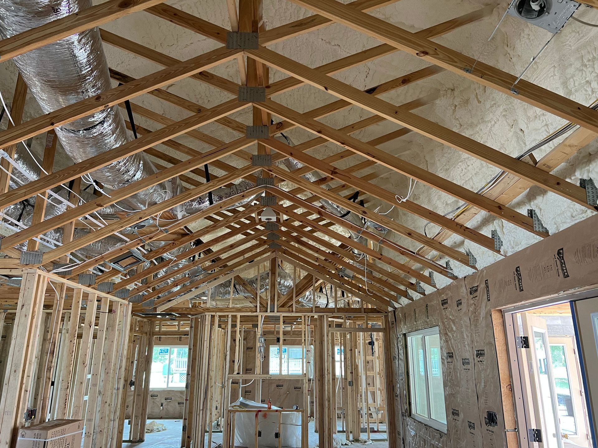 The inside of a house being built with a vaulted ceiling.