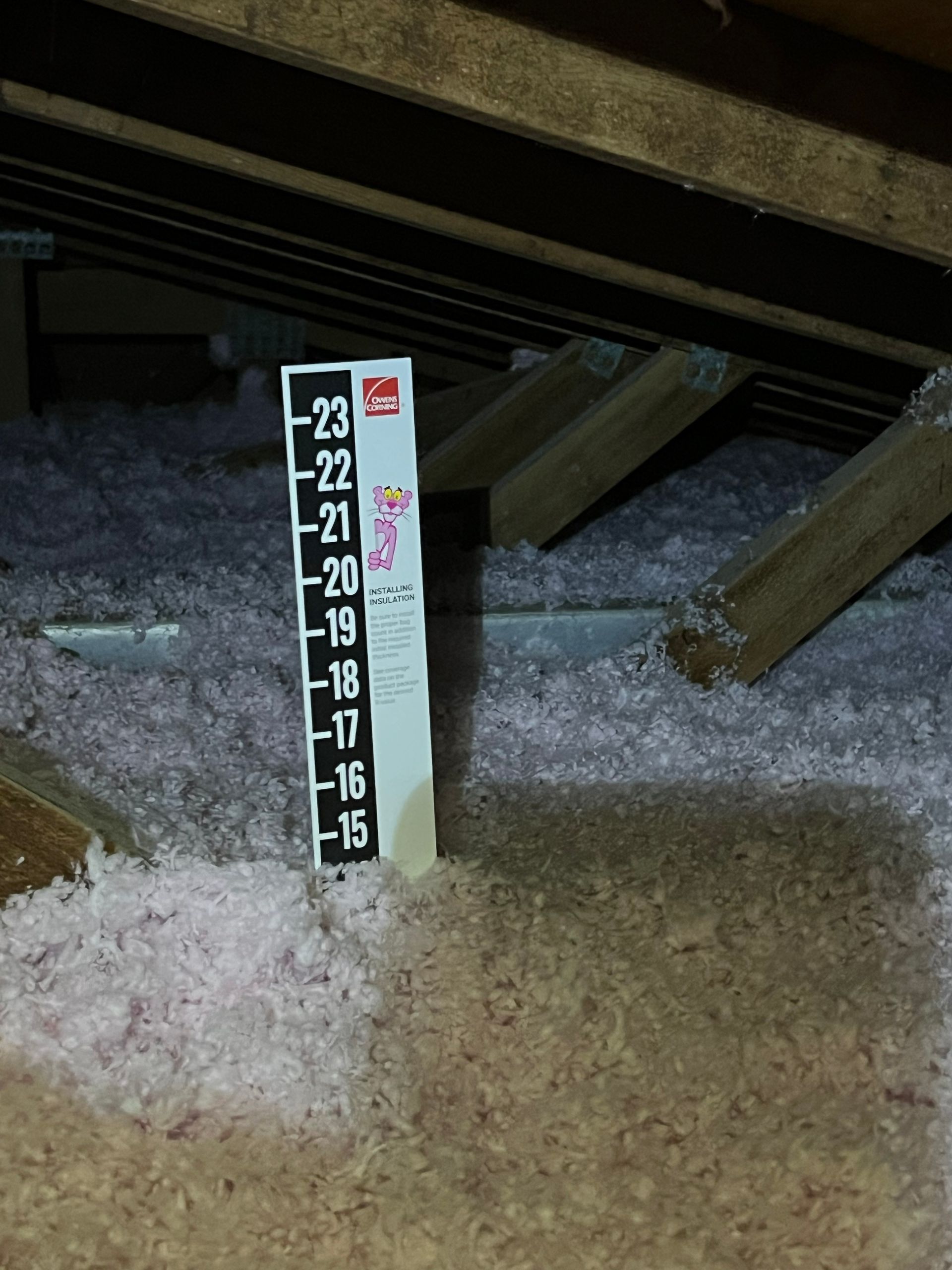 A thermometer in an attic with the number 23 on it