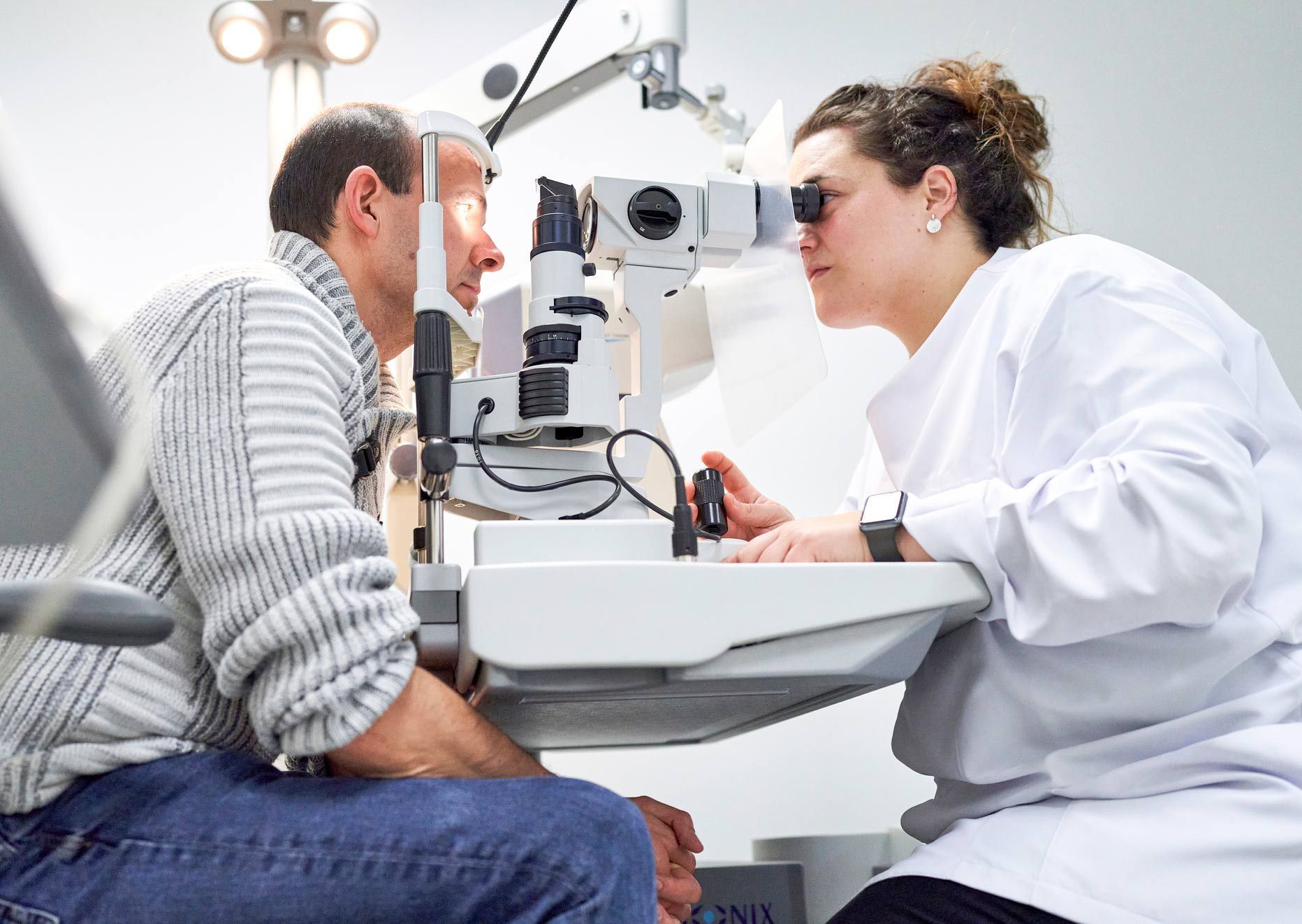 Ophthalmologist examining male patient | Townsville, QLD | Optical Superstore Townsville