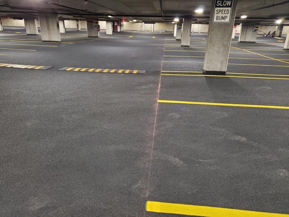 A parking garage with yellow lines and a sign that says slow