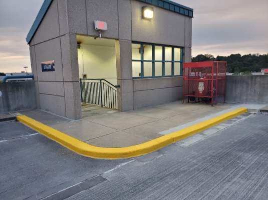 A building with stairs and a yellow curb in front of it
